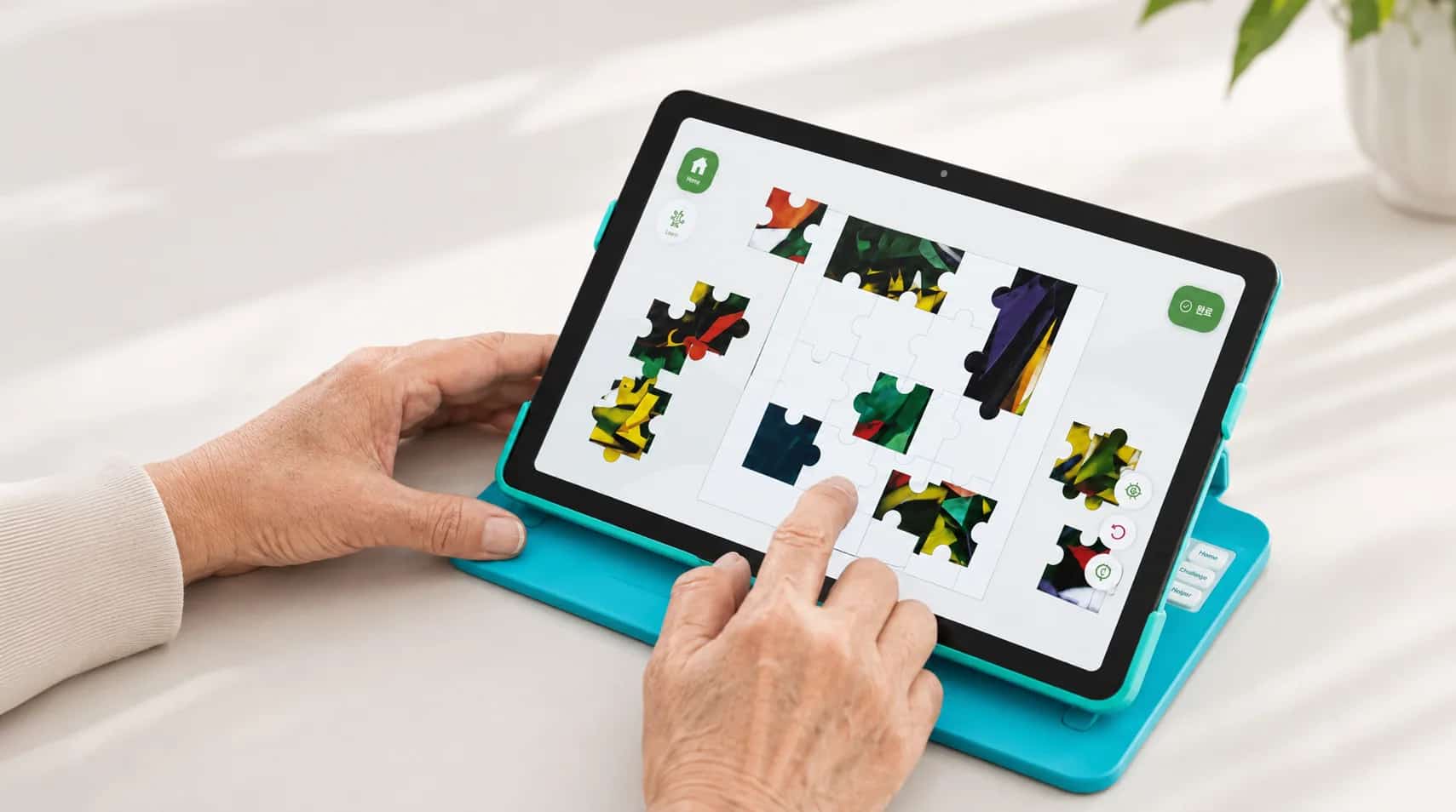Hands working through a puzzle activity on a tablet