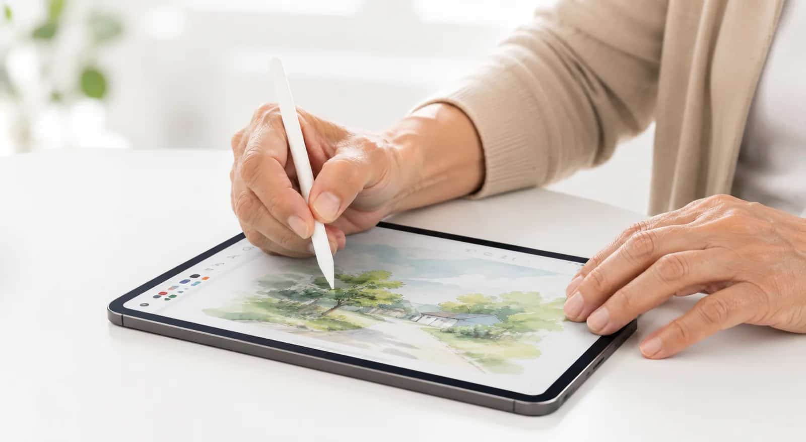 A watercolor landscape being painted on a tablet
